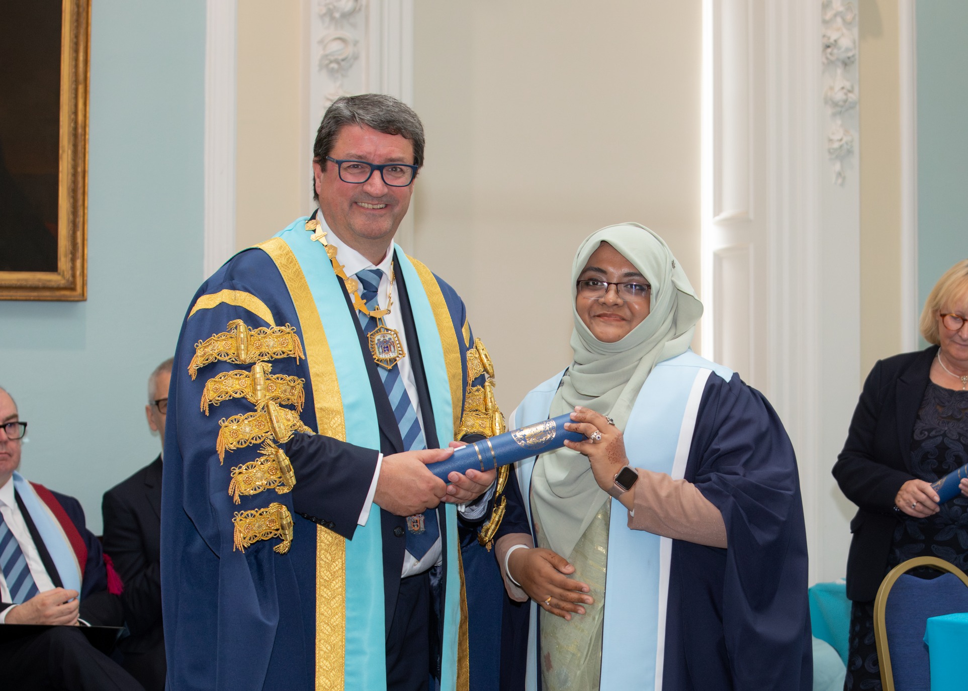 Dr. Peu receiving the MRCS diploma from the Royal College of Surgeons of Edinburgh